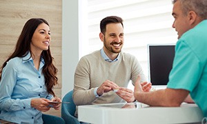 Couple discusses matters with dentist