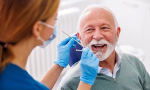 Man smiles at dentist