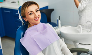 Woman smiling while sitting in treatment chair